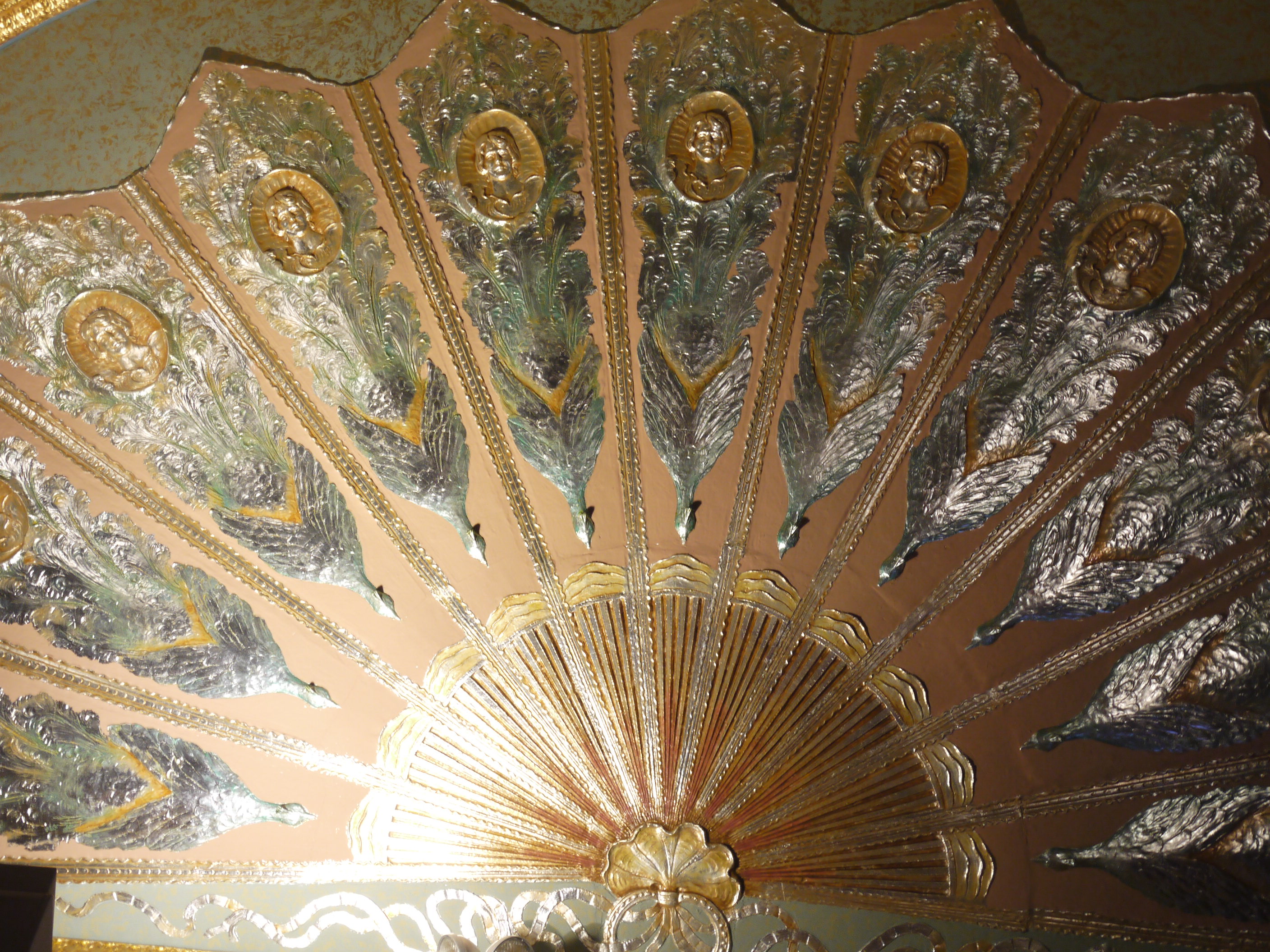 A spellbinding peacock's tail carved onto the ceiling.