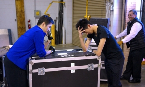 Dancers Andy Shia and Ben Chen, as well as oboist Torsten Trey face the dilemma of the year&rsquo;s very first truck loading. How do you get everything to fit? Don&rsquo;t worry, eventually they somehow did. (photo by Jun Liang)