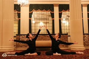 Chinese dance movements and postures often have metaphorical meanings. This one is called the yáng zhǎng pose. The word yang also means sun, and in its honor dancers Angie Lin (left) and Kaidi Wu simulate cradling sunshine. This photo was taken at the Hanover Theatre in Worcester, MA, where Shen Yun North America Company performed.(Photo by dancer Yuqin Xin)
