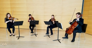 And the soothing notes of a little ad hoc chamber music quartet. At the Bregenz Festspielhaus, (from left) Concertmaster Astrid Martig, first violinist Li Fan, viola player Paulina Chau, and cellist Jacob Fowler enjoy each other’s company and music. (Photo by oboist Leen De Blauwe) 
