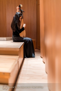 Pipa player Miao-Tzu Chiu tunes her pear-shaped instrument.
