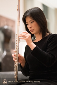 Principal flutist Chia-Jung Lee prepares her flute for the concert.
