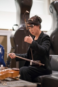 Before opening night at Carnegie Hall, erhu soloist Lu Sun takes a quiet moment to warm up.
