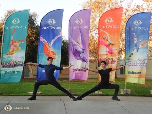 Dancers Danny Li and Henry Hong (right) pose in front of five colorful Shen Yun banners in Escondido. Currently, this company is in London for 14 sold-out shows! (Photo by dancer Tony Zhao)
