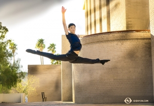 Dancer Aaron Huynh gets good height while leaping outside the Tucson Music Hall. (Photo by Principal Dancer Kenji Kobayashi)
