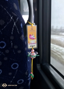 Onward to Canada! Locals in Vancouver showered the Shen Yun Touring Company with handmade lotus flowers before they left. Singer Rachael Bastick hung one from her bus seat to provide a happy contrast to the gloomy wet day outside. (Photo by Rachael Bastick)