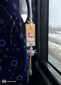 Onward to Canada! Locals in Vancouver showered the Shen Yun Touring Company with handmade lotus flowers before they left. Singer Rachael Bastick hung one from her bus seat to provide a happy contrast to the gloomy wet day outside. (Photo by Rachael Bastick)
