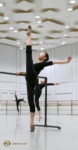 Dancer Cecilia Wang holds her leg at 180 degrees in the open space of the practice room. (Photo by Rachael Bastick) 
