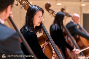 La bassista Juexiao Zhang durante un’esibizione sul palco. Questa è la sua terza stagione con l’orchestra sinfonica
