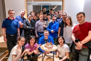 Orchestra members celebrating Principal Trumpet Eric Robins' birthday in Seoul.
