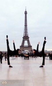 We're so excited to be in Paris! Flanking the 130-year-old Eiffel Tower are dancers Olivia Zhang and Elsie Shi (L to R). (Photo by percussionist Tiffany Yu)
