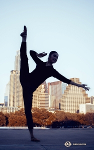 Meanwhile in Austin, TX, dancer Lily Wang touches her toes to the sky with the cityscape as a backdrop. (Photo by dancer Michelle Wu)
