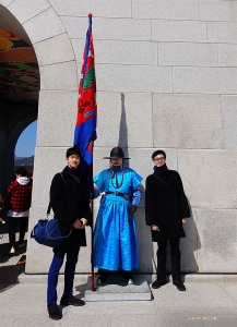 Shen Yun World Company wystąpi w pięciu miastach w Korei Południowej w ciągu dwóch tygodni. Tancerze Jungsu Lee (po lewej) i Jun Liang pozują z królewskim gwardzistą w pałacu Gyeongbokgung. (Jeff Chuang)
