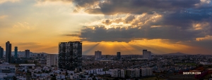 A stunning panoramic photo of the densely populated city at the end of the day. 

