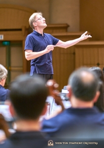 Conductor Dmitry Russu leads rehearsal.