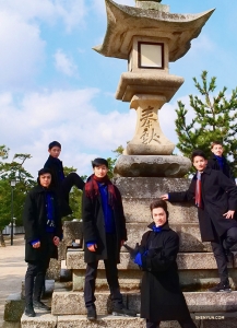 Dancers gather around one of the many stone lanterns on the island.