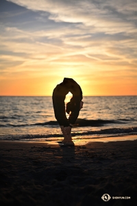 Dancer Connie Kuang wraps herself around the glowing sun.