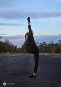 Dancer Jiajia Li steps off the bus and takes the opportunity to do some stretching in the parking lot (she didn't even warm up before doing this!).

(Photo by Kaidi Wu)