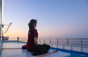 Meanwhile, in Europe, the Shen Yun New York Company is heading to Sicily by ferry. Deep in meditation, dancer Jessica Si enjoys inner and outer peace before sunset.
