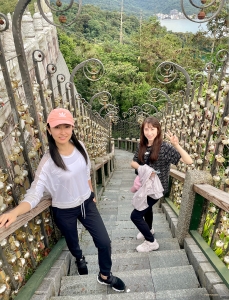 On the way to see a local temple, Nancy Zhang and Rachael Bastick take a break on the Year of Steps, whose 366 steps symbolize the days of a (leap) year, each marked with a calendar date.
