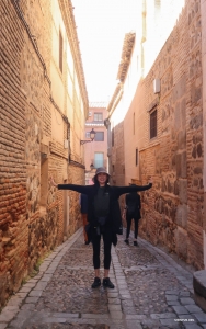 Principal dancer Angelia Wang spreads her wings in a narrow alleyway, embracing the beauty of Spain's winding streets.