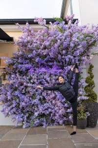 This dancer knows the importance of preparation—she warms up before hitting the shops at La Vallee Village in Serris, France.