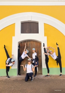 In the vibrant Old San Juan district, known for its colorful buildings and lively streets, dancers beam with joy, adding their own splash of color to the charming scenery.