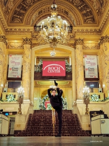 In the lobby of Boston's Wang Theatre, dancer Justin Shi spreads holiday cheer through open arms and high kicks.