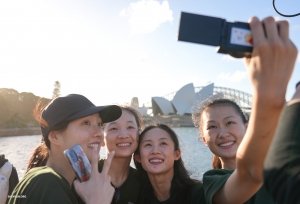 Who's up for a fun-filled little cruise? Can you guess where these dancers are capturing this magical moment? Hint: It involves an iconic roof and stunning harbor views!