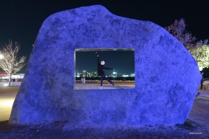 Near the harbor, a dancer finds herself perfectly framed within the cutout of this sculpted rock.