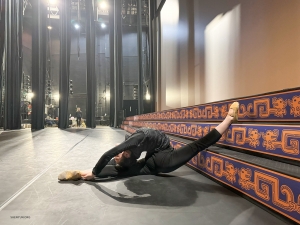 Of course, the tour isn't all beaches and excursions—here, a female dancer dedicates time to stretch, exemplifying the hard work and discipline that form the foundation of every breathtaking performance.