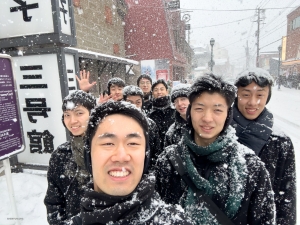 Embracing a frosty adventure, this group of male dancers are all smiles amidst a flurry of snowflakes.
